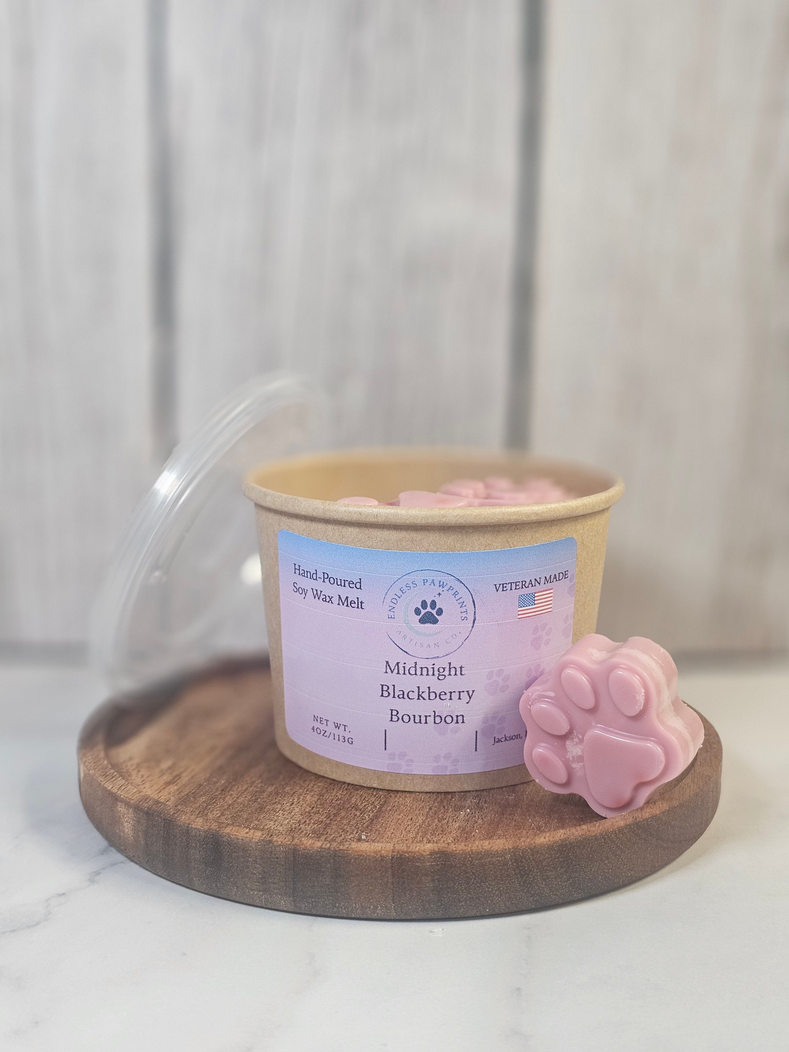 Container of wax melts on a wooden tray in front of a  blurred wooden background