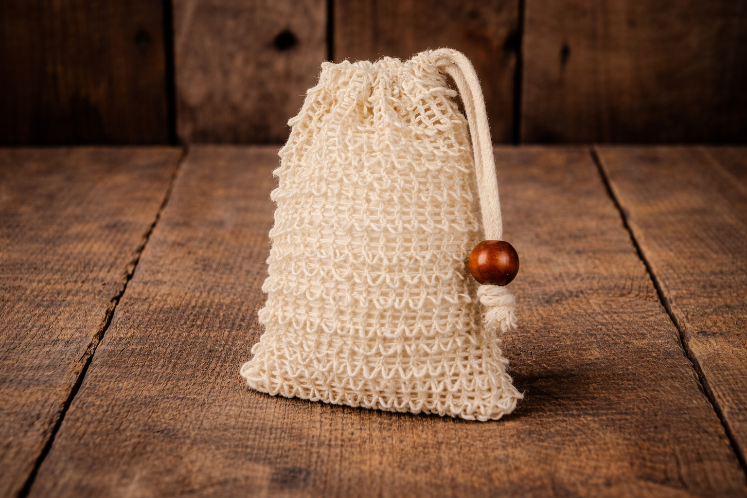 Soap saver bag against a wooden background