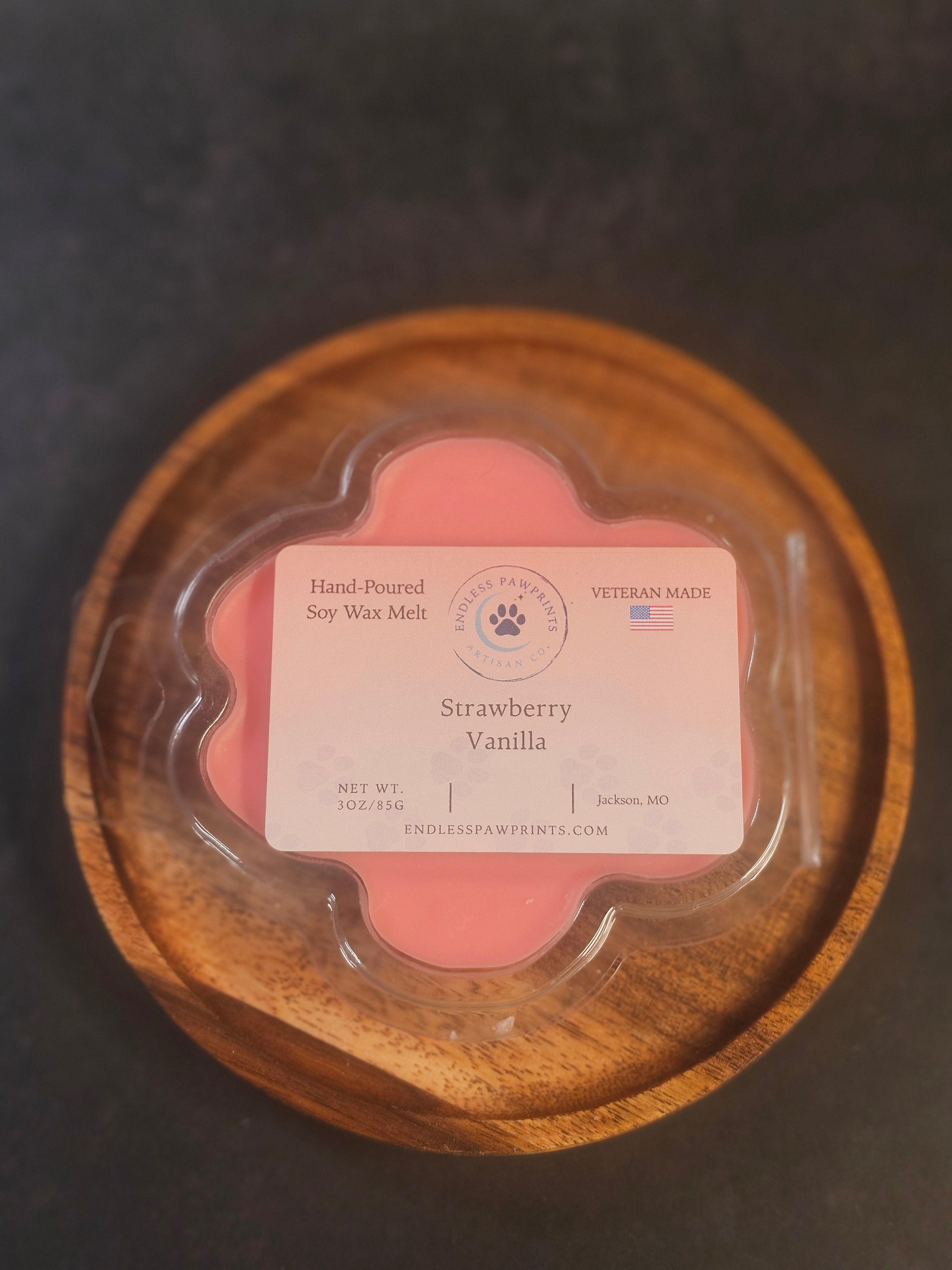 Strawberry vanilla wax melt in a paw print clam shell
