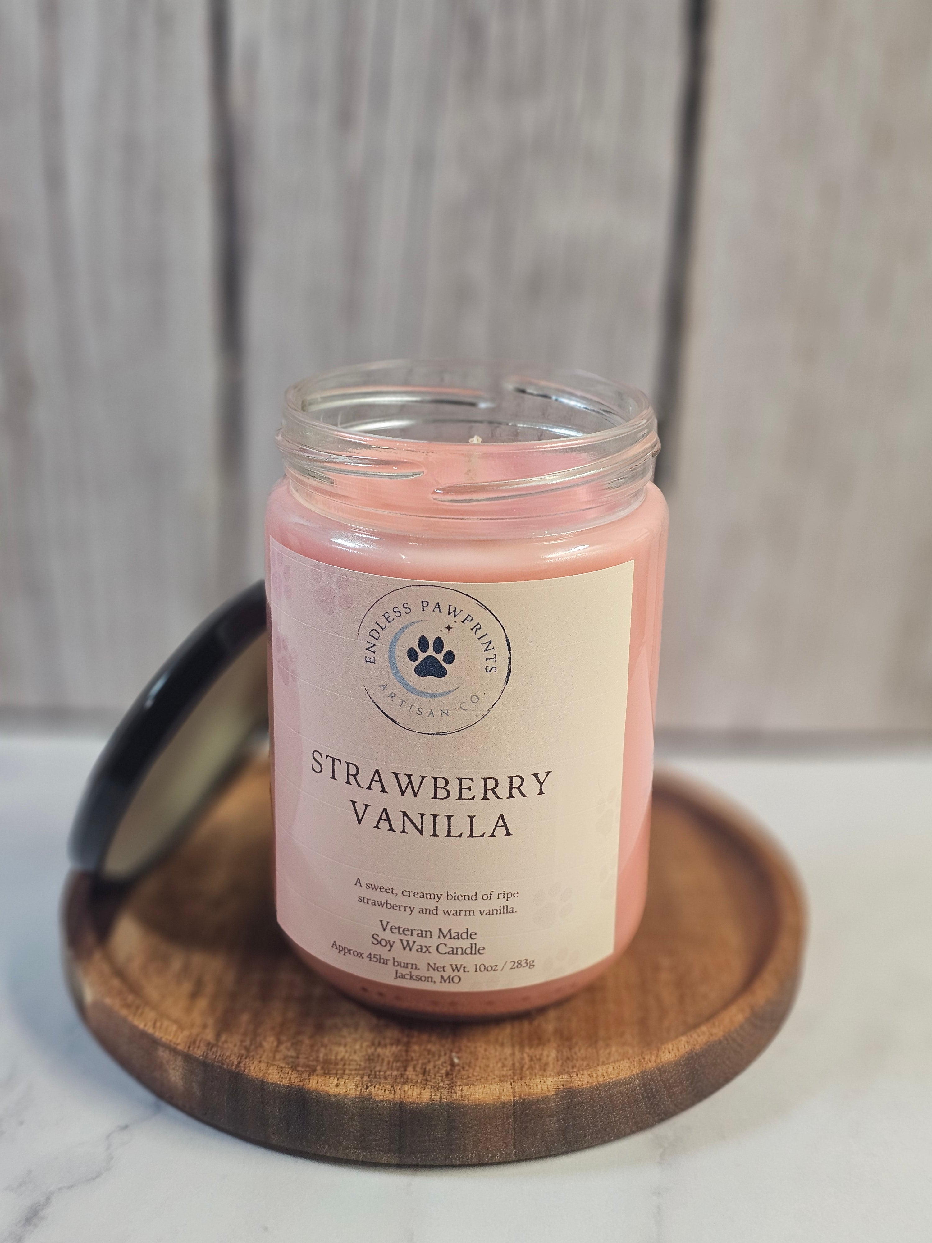 Strawberry Vanilla candle in a wooden holder on a marble surface